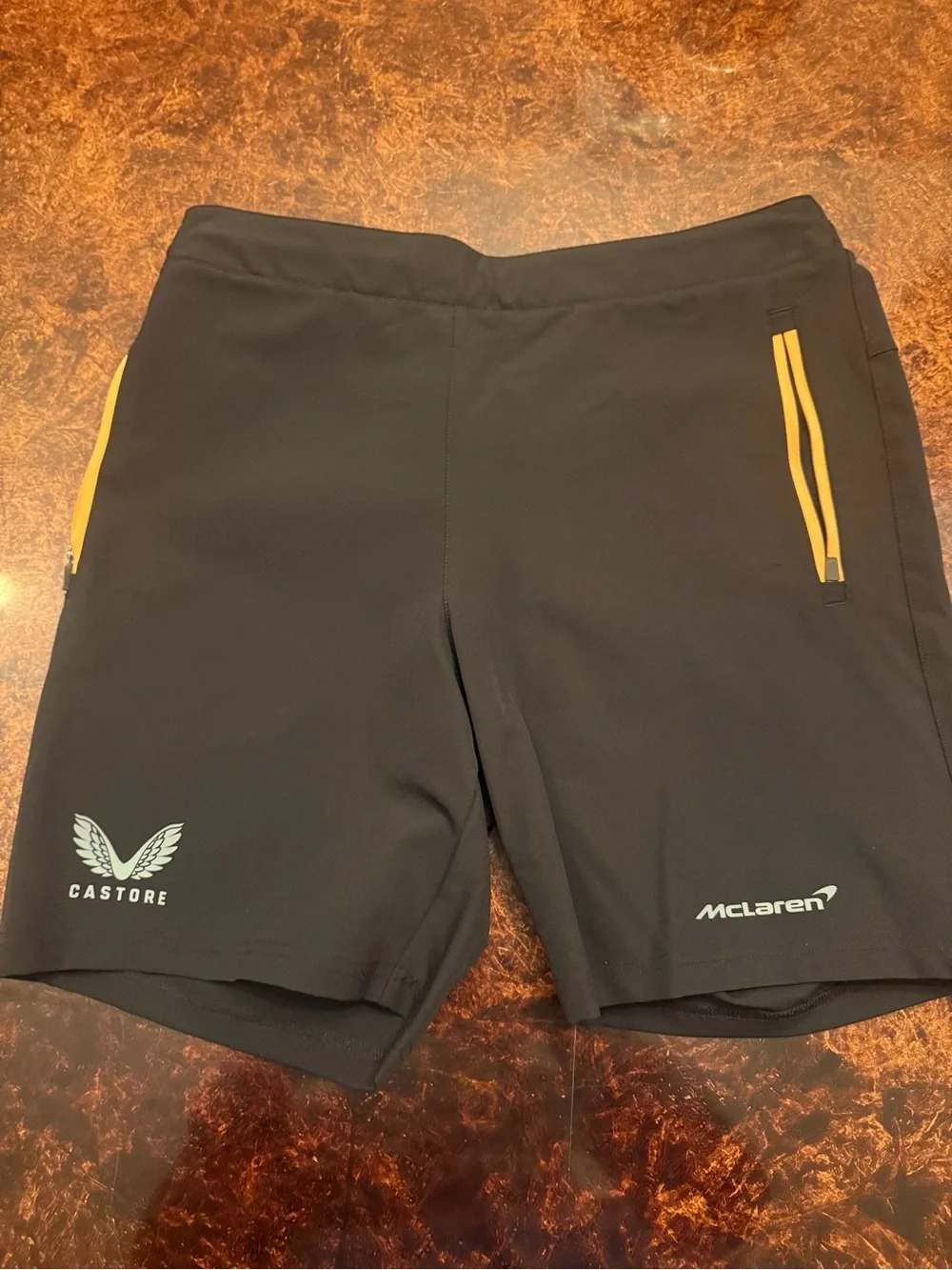 Castore x McLaren Men's Black Athletic Shorts with Yellow Zip Accents